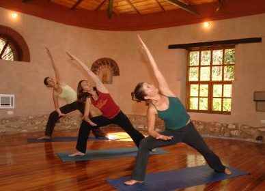 Romi Cumes leading yoga class in Yogawasi